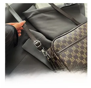 Detail of silver adjustable buckle and lobster clasp on vintage monogram crossbody bag