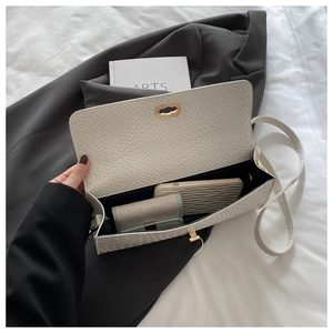Macro shot of white woven texture bag showing spacious interior for phone and wallet
