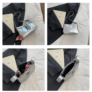 Silver metallic shoulder bag with drawstring detail and spacious inner compartments