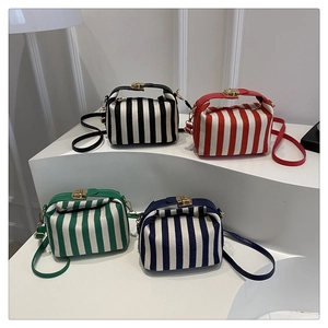 Detailed display of striped crossbody bags in four colors with gold metal locks