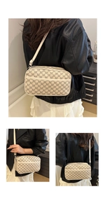 Detail of beige camera bag with M-pattern monogram print and slim crossbody strap