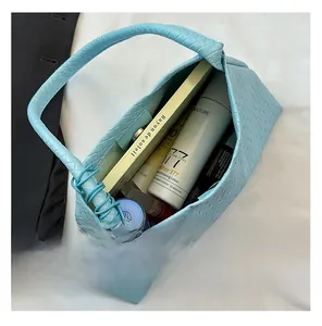 Detail view of woven light blue tote interior showing spacious capacity for essentials