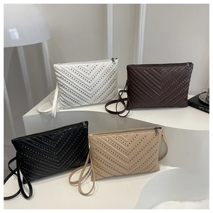 Detail of quilted envelope bags with metal rivets and zipper in four stylish colors