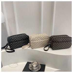 Three elegant vintage pattern crossbody bags displayed on a modern minimalist white podium