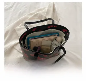 Top view of large cherry print tote bag showing storage for tablet and essentials