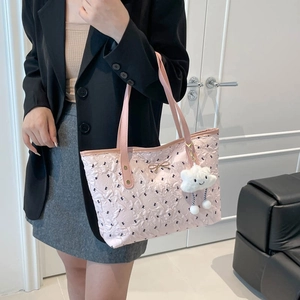 Pink embossed tote bag with a golden bow and plush cloud charm for modern women