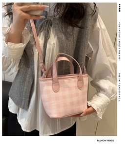 Detail of pink gingham mini tote bag with adjustable leather strap and gold hardware