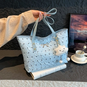 Sky blue quilted tote bag with black butterfly patterns and cute cloud charm detail