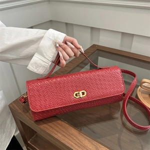 Red woven rectangular handbag with golden metal hardware and cross-weave leather texture