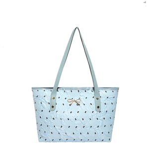Light blue quilted tote bag with rabbit print and golden bow accessory for women