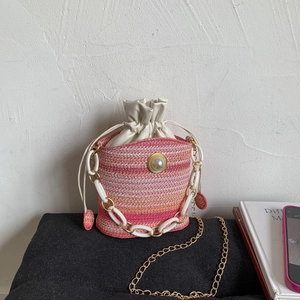Pink and orange gradient woven bucket bag with pearl detail and gold chain strap