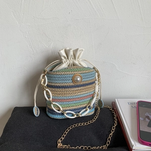Chic multi-color striped woven bucket bag with pearl detail and gold chain strap