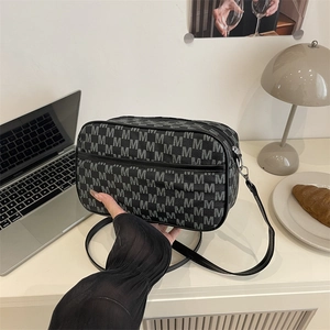 Minimalist rectangular crossbody bag with grey monogram pattern and leather strap