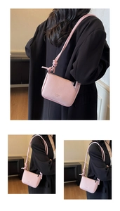 Detail of pink small crossbody bag with lychee grain texture and thin rope strap
