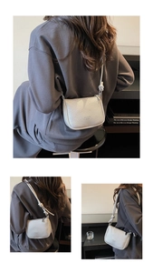 Close-up of litchi grain leather crossbody bag with decorative knotted shoulder strap