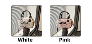 Detail of white and pink pleated handbags with black bows and pearl accents