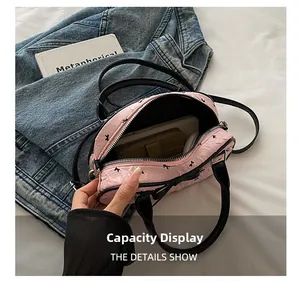 Internal capacity display of the pink textured mini tote bag showing phone and wallet