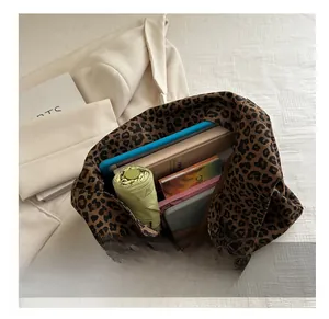 Leopard print tote bag interior showing capacity for umbrella, books and tablet