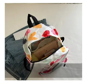 Interior view showing large capacity for books and tablet in heart-print backpack