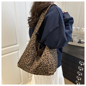 Detail view of large leopard print canvas tote bag styled for casual autumn fashion wear