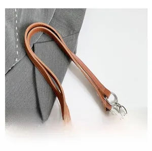 Close-up of leather shoulder strap with silver metal chain on vintage printed tote bag