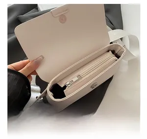 Detail showing inner zipper pocket and silver magnetic closure of the cream PU leather bag