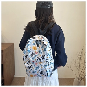 Detailed view of white canvas backpack with tropical palm tree and pineapple print