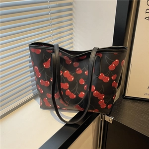 Black tote bag with red cherry print and dual shoulder straps for casual fashion