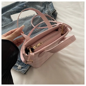 Detailed top view of pink checkered tote bag with gold zipper and stylish handle straps