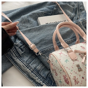 Détail du sac Boston avec texture gaufrée 3D et motifs d'ours et de fraises