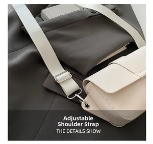 Detail of adjustable wide fabric strap on beige crossbody bag with silver hardware