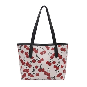 Minimalist cream tote bag with red cherry print and black shoulder straps for daily use