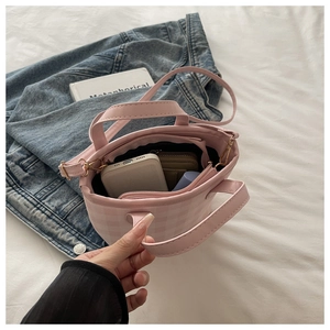 Interior view showing compartments of pink plaid handbag with phone and wallet inside
