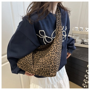 Detail of leopard print cotton tote bag showing large capacity and soft fabric texture