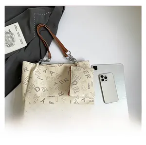 Detail showing capacity of cream printed tote bag with tablet and matching pouch