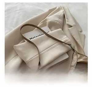 Close-up of vintage brown leather shoulder bag with rustic metal buckle and fold detail