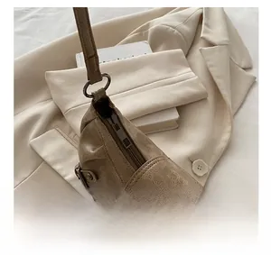 Detail view of smooth metal zipper and vintage brown faux leather on commuter tote