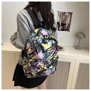 Detail of colorful graffiti print backpack with comfortable wide black shoulder straps
