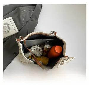 Top view showing the spacious interior of this tote bag fitting a laptop and daily items