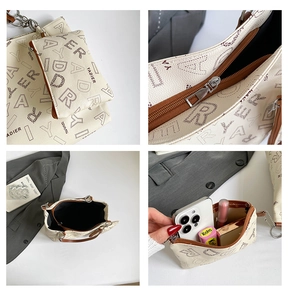 Détails du sac cabas beige avec imprimé lettres, montrant la fermeture éclair et l'intérieur