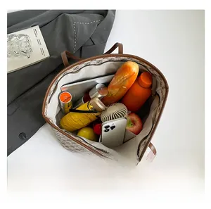Spacious tote bag interior showing capacity for tablet, umbrella, and daily items