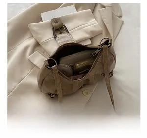 Detailed interior of vintage distressed underarm bag showing spacious storage for essentials