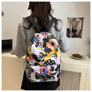 Detailed view of trendy graffiti pattern backpack with colorful patchwork design on student