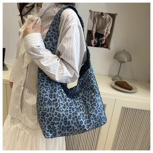 Detail shot of the blue leopard print pattern on a large capacity canvas tote bag