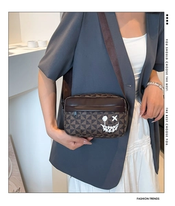 Crossbody phone bag featuring brown checkerboard pattern and a white graffiti smiley face