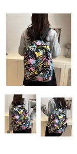Detail of artistic graffiti nylon backpack with wide straps and vibrant abstract pattern
