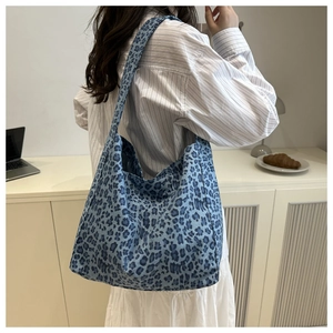 Detail of blue leopard print tote bag showing spacious design and canvas material