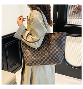 Detail view of large checkered tote bag with shoulder straps for commute wear