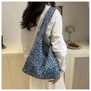 Detail view of the blue leopard print tote bag shoulder strap and spacious fabric design