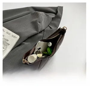 Interior view of brown quilted shoulder bag showing large capacity for essentials
